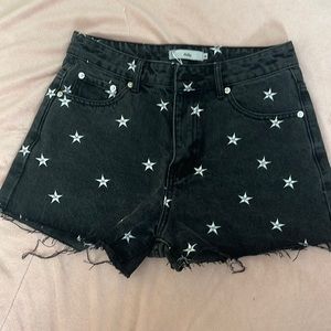 Black denim shorts with white stars